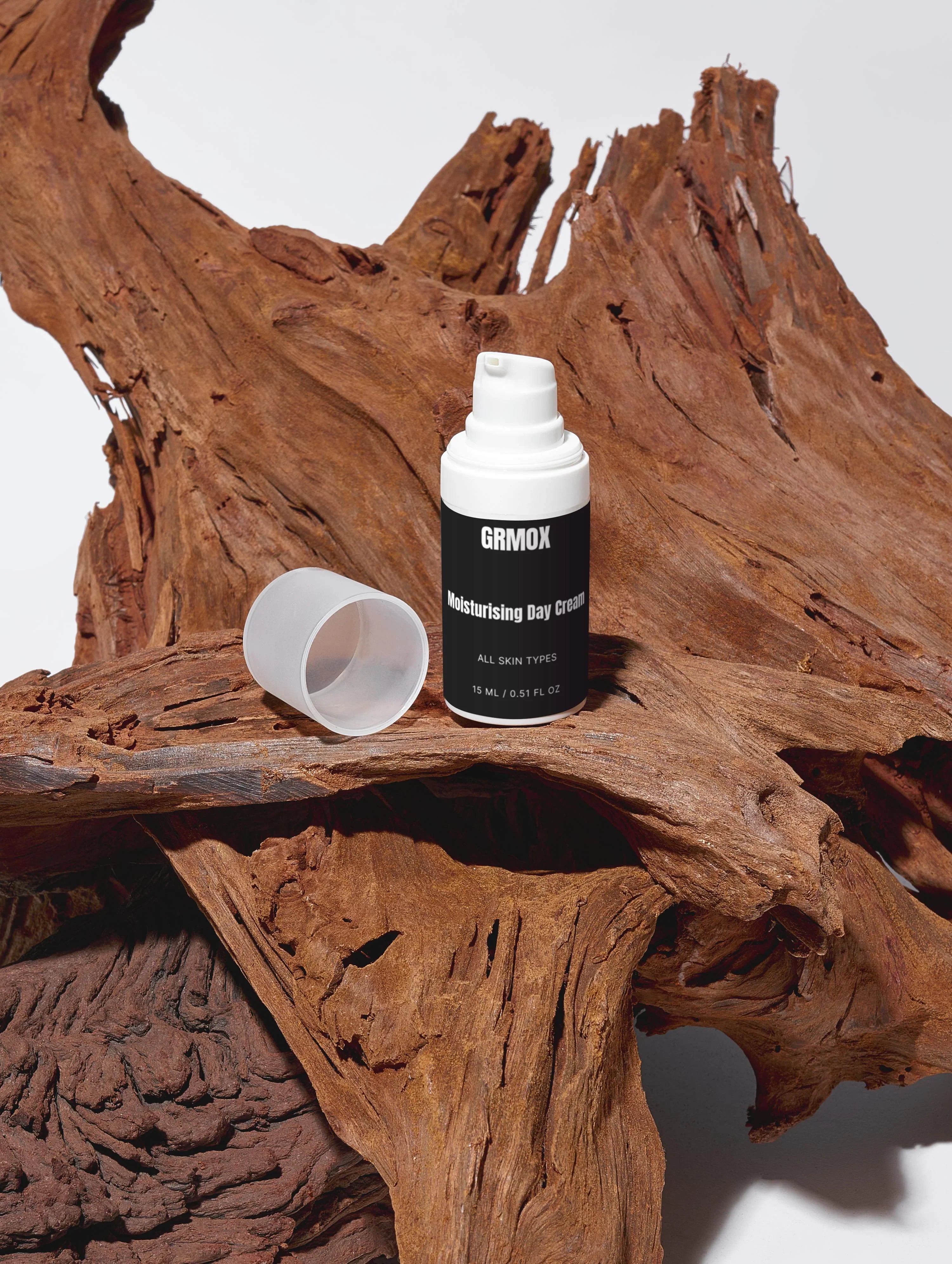 GRMOX Moisturising Day Cream for all skin types, 15ml, displayed on rustic driftwood with cap off
