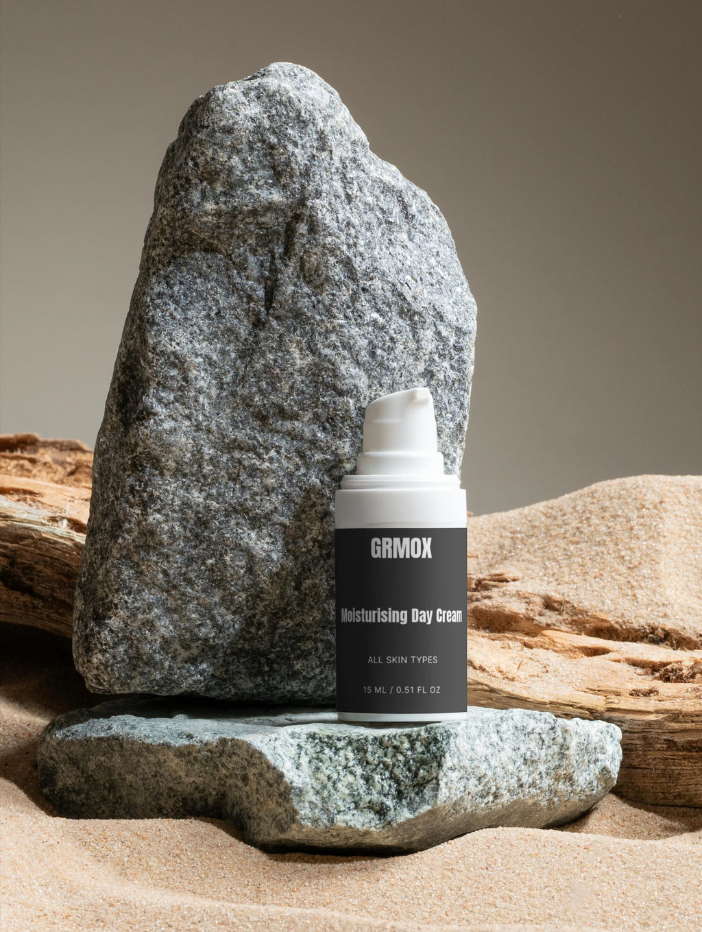 GRMOX Moisturising Day Cream for all skin types, 15ml, displayed on rocks with sand background