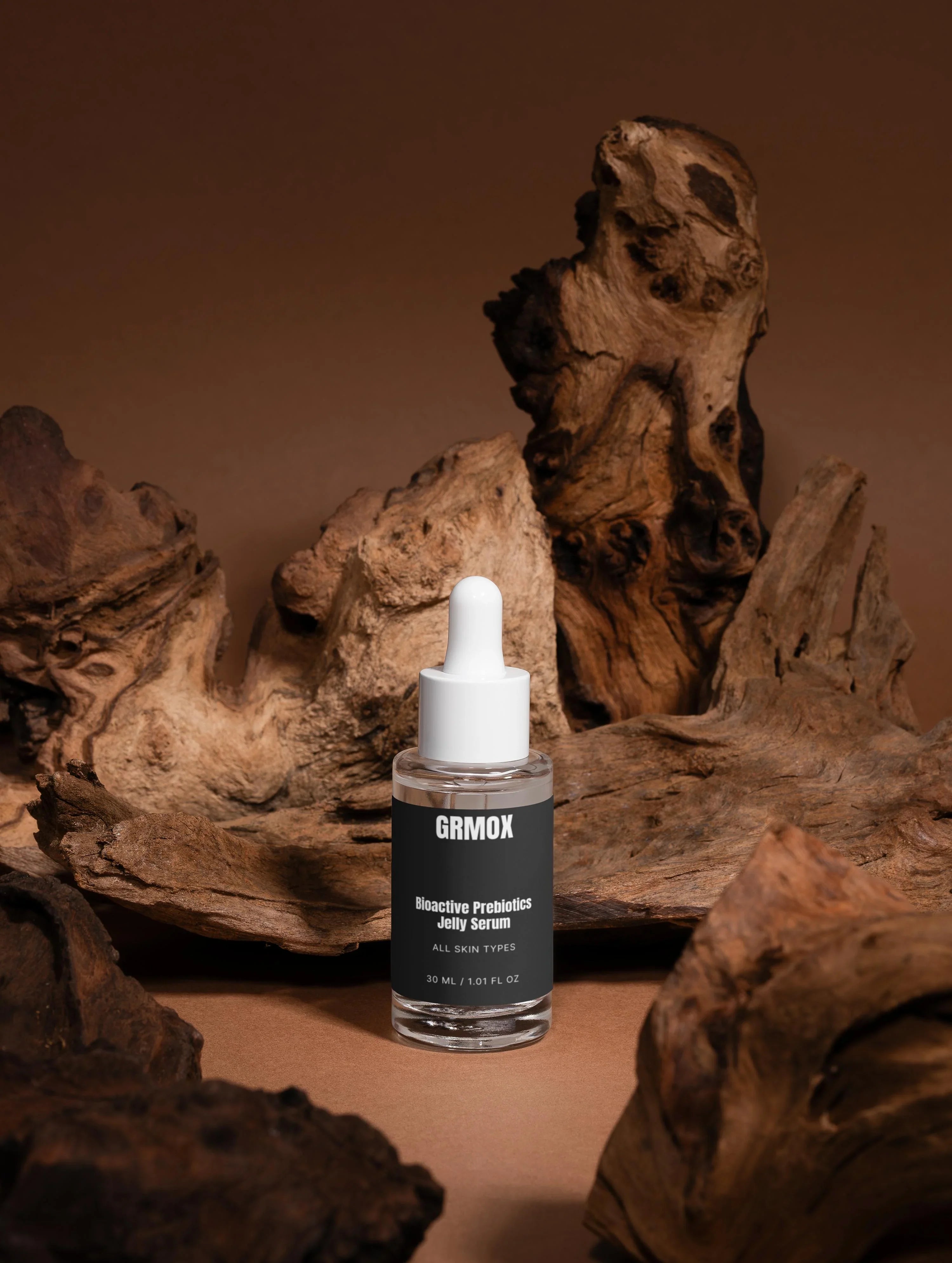 GRMOX Bioactive Prebiotics Jelly Serum for all skin types, 30ml bottle with dropper on rustic wood background