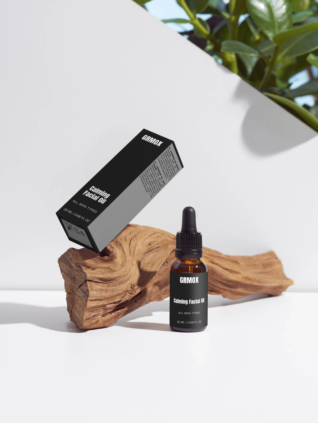 GRMOX Calming Facial Oil for all skin types, 20ml bottle with dropper and packaging on wood, green plant background