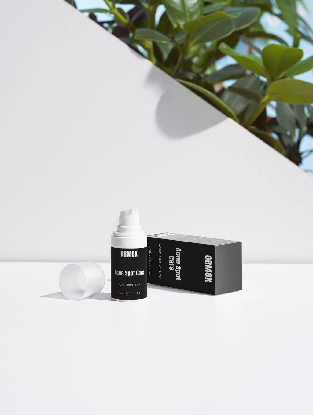 GRMOX Acne Spot Care for acne prone skin, 15ml bottle with box, white background and green plant