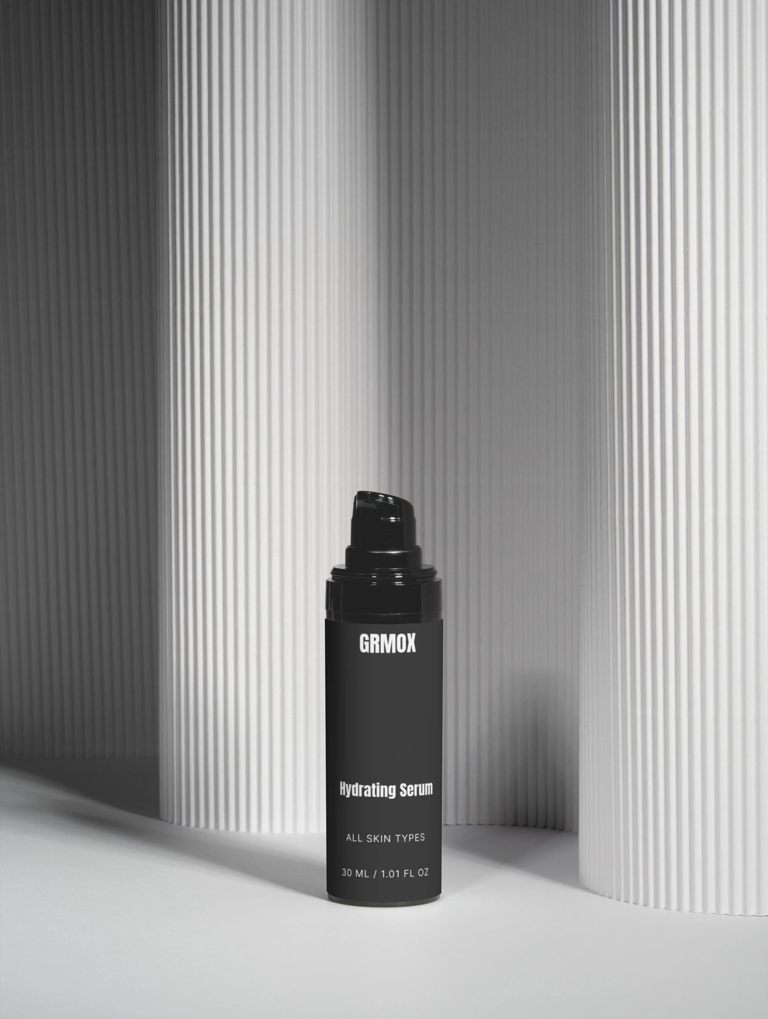 GRMOX Hydrating Serum for all skin types, 30ml bottle against minimalist striped background
