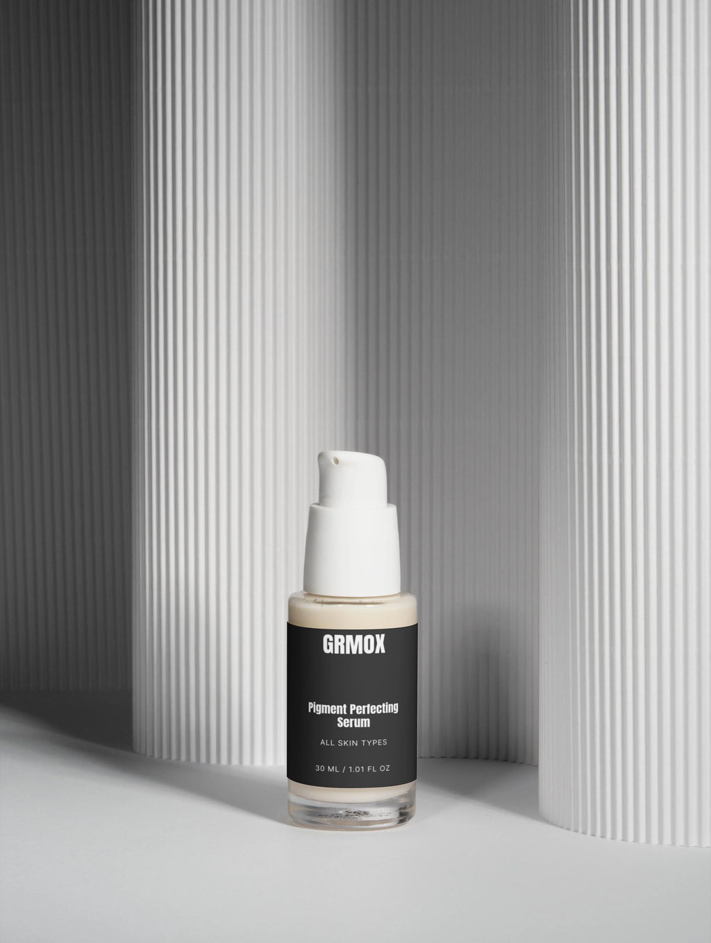 GRMOX Pigment Perfecting Serum for all skin types, 30ml bottle with pump, minimalist white background