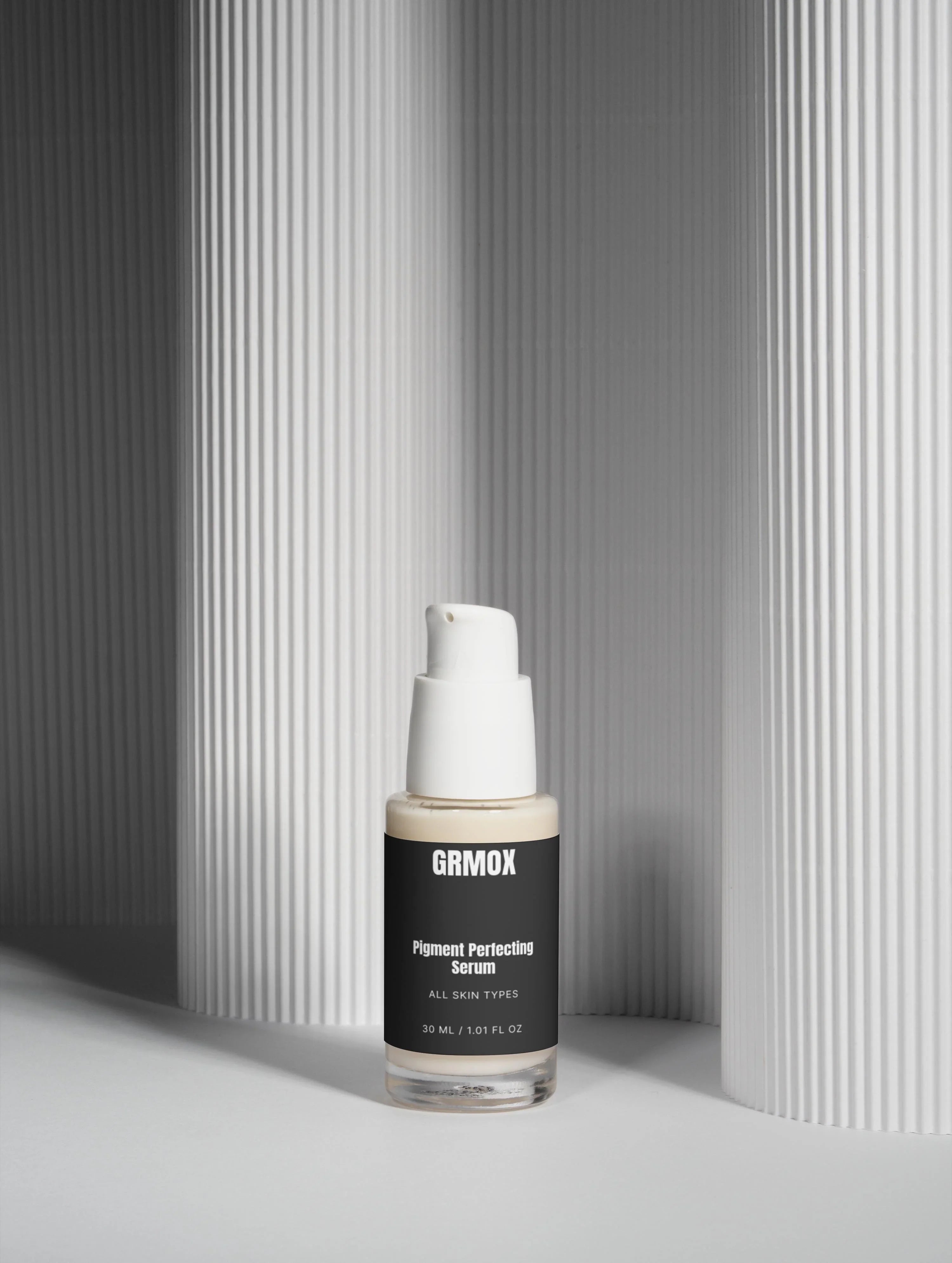 GRMOX Pigment Perfecting Serum for all skin types, 30ml bottle with pump, minimalist white background