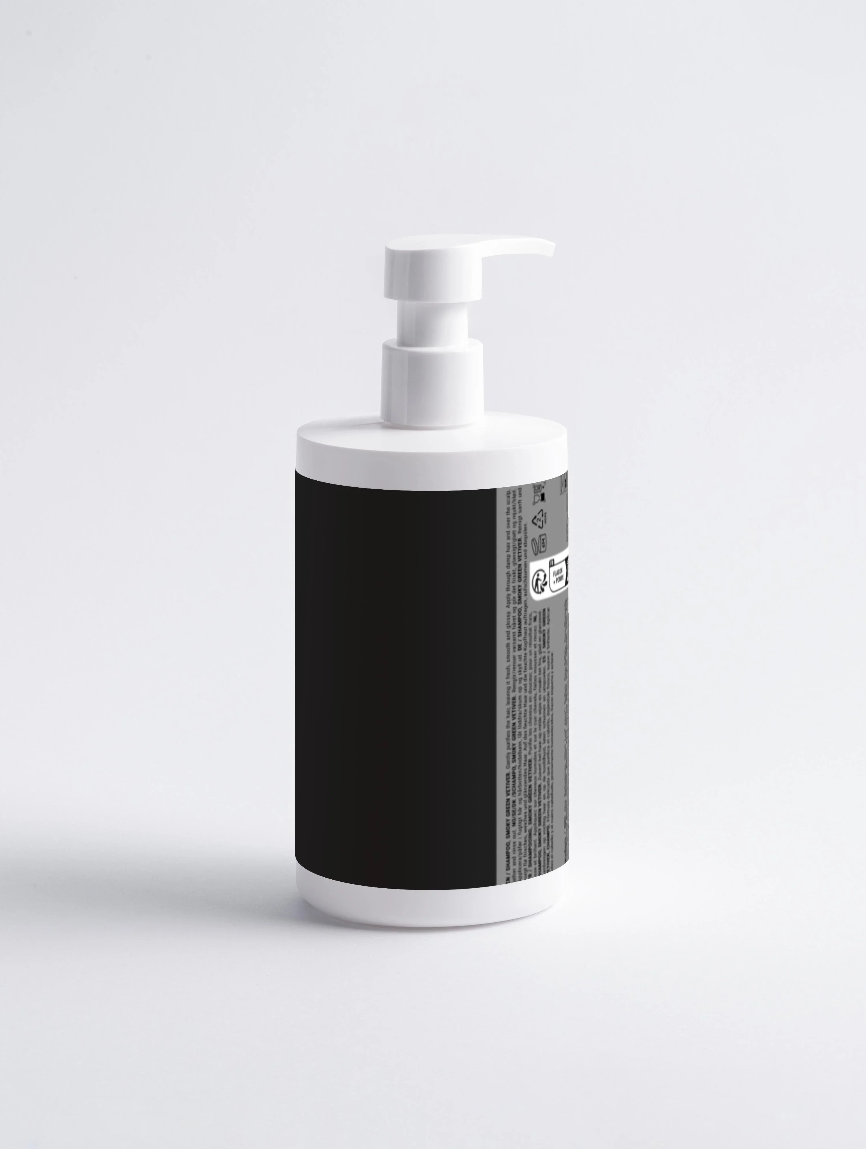 White pump bottle with black label, featuring Smoky Green Vetiver shampoo text on side