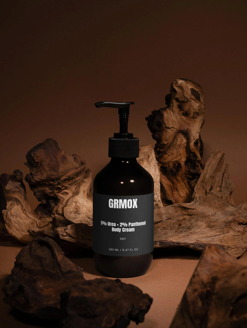 GRMOX 5% Urea + 2% Panthenol Body Cream for dry skin, 280ml, in sleek black bottle with pump, styled with rustic driftwood.