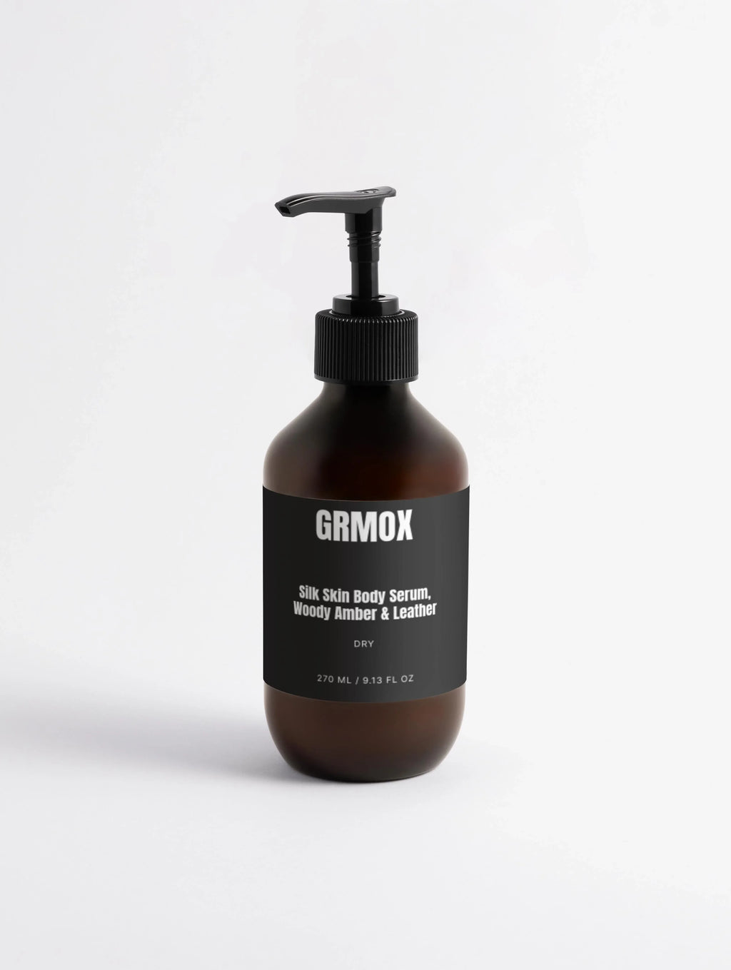 Silk Skin Body Serum with Woody Amber & Leather scent in amber glass bottle with black pump
