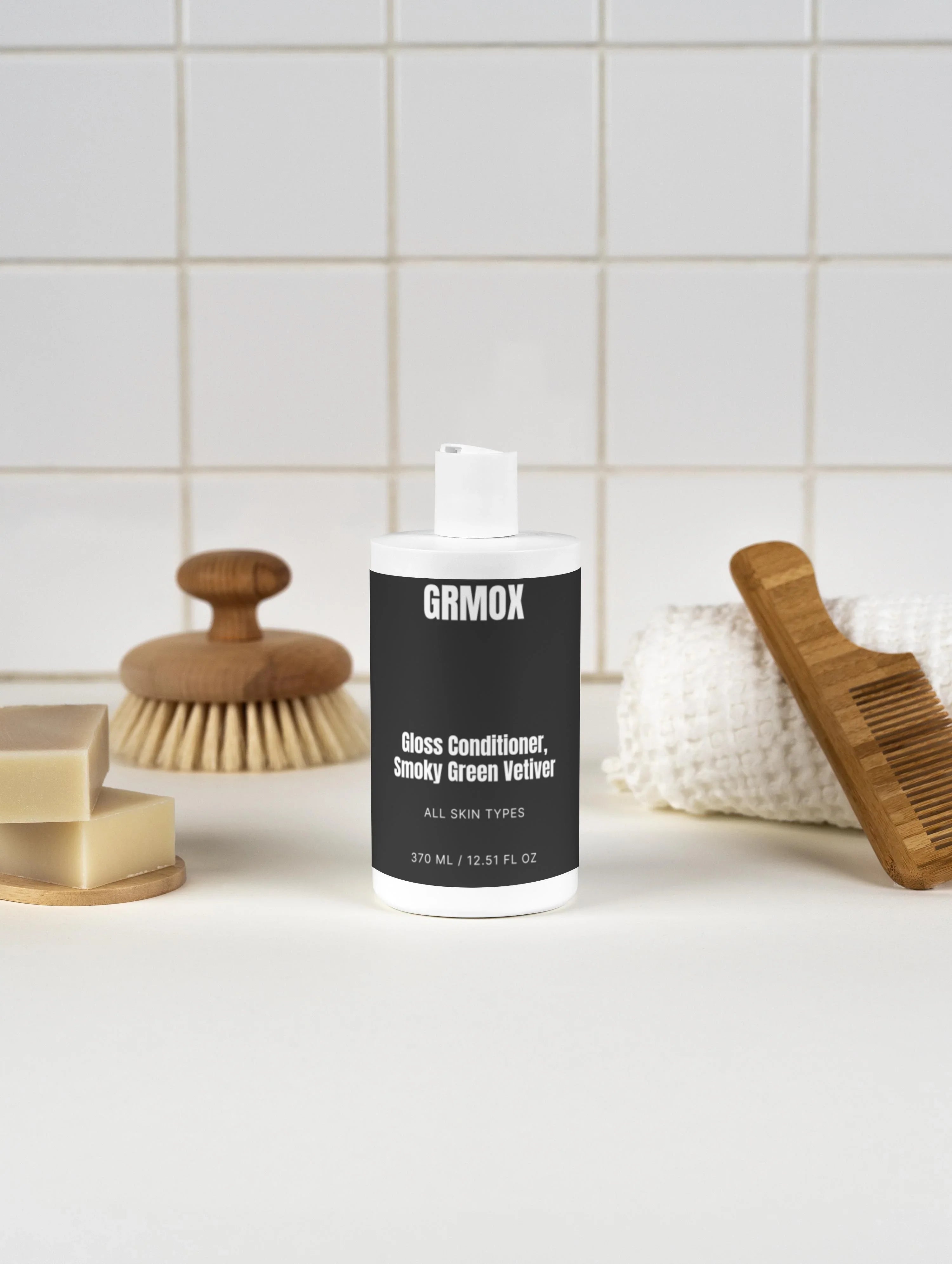 GRMOX Gloss Conditioner, Smoky Green Vetiver for all skin types, 370ml, with wooden bath accessories on tiled background
