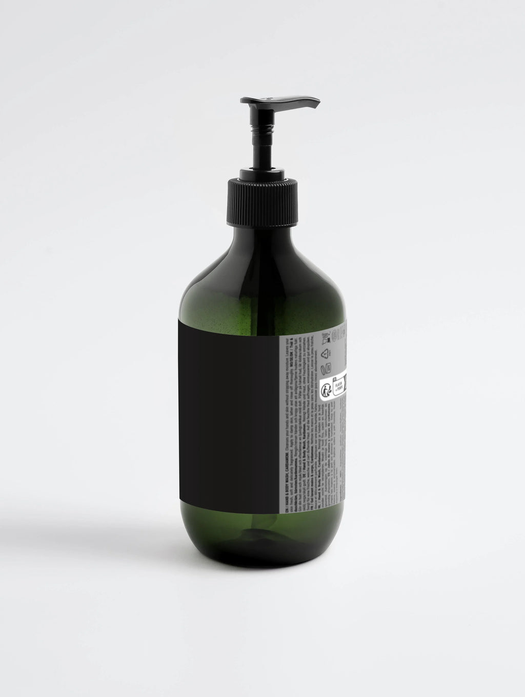 Green glass bottle with black pump dispenser, labeled hand and body wash, minimalist design