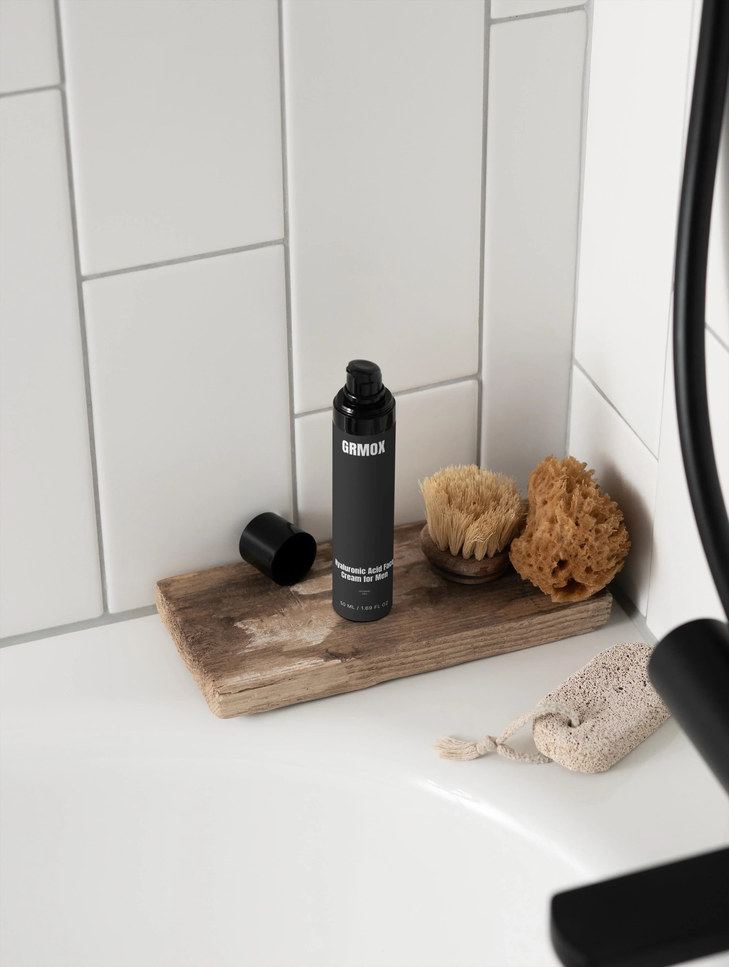 GRMOX Hyaluronic Acid Face Cream for Men on wooden tray with bath brush and sponge in bathroom