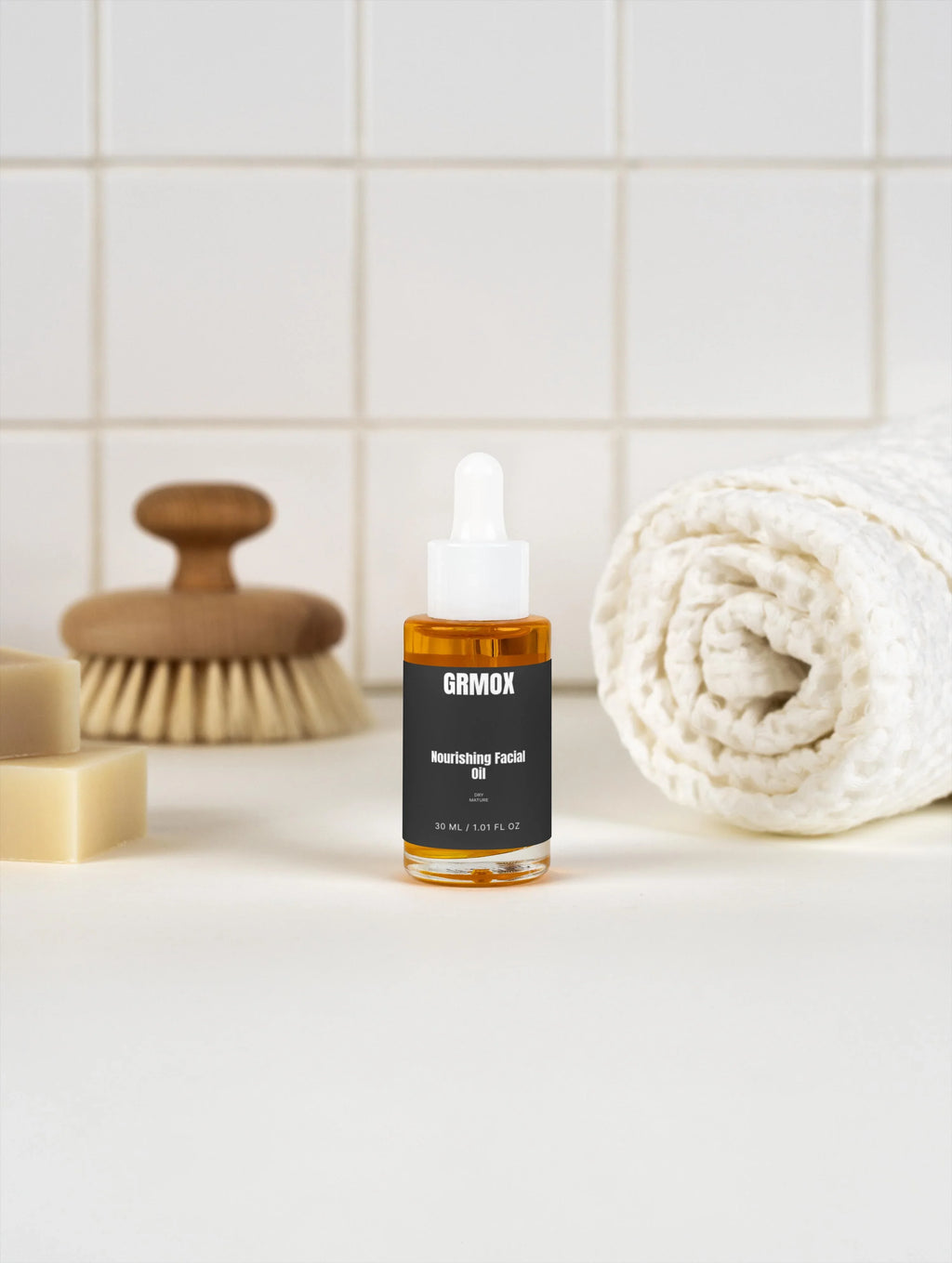GRMOX Nourishing Facial Oil for dry mature skin, 30ml bottle with dropper, beside towel and brush