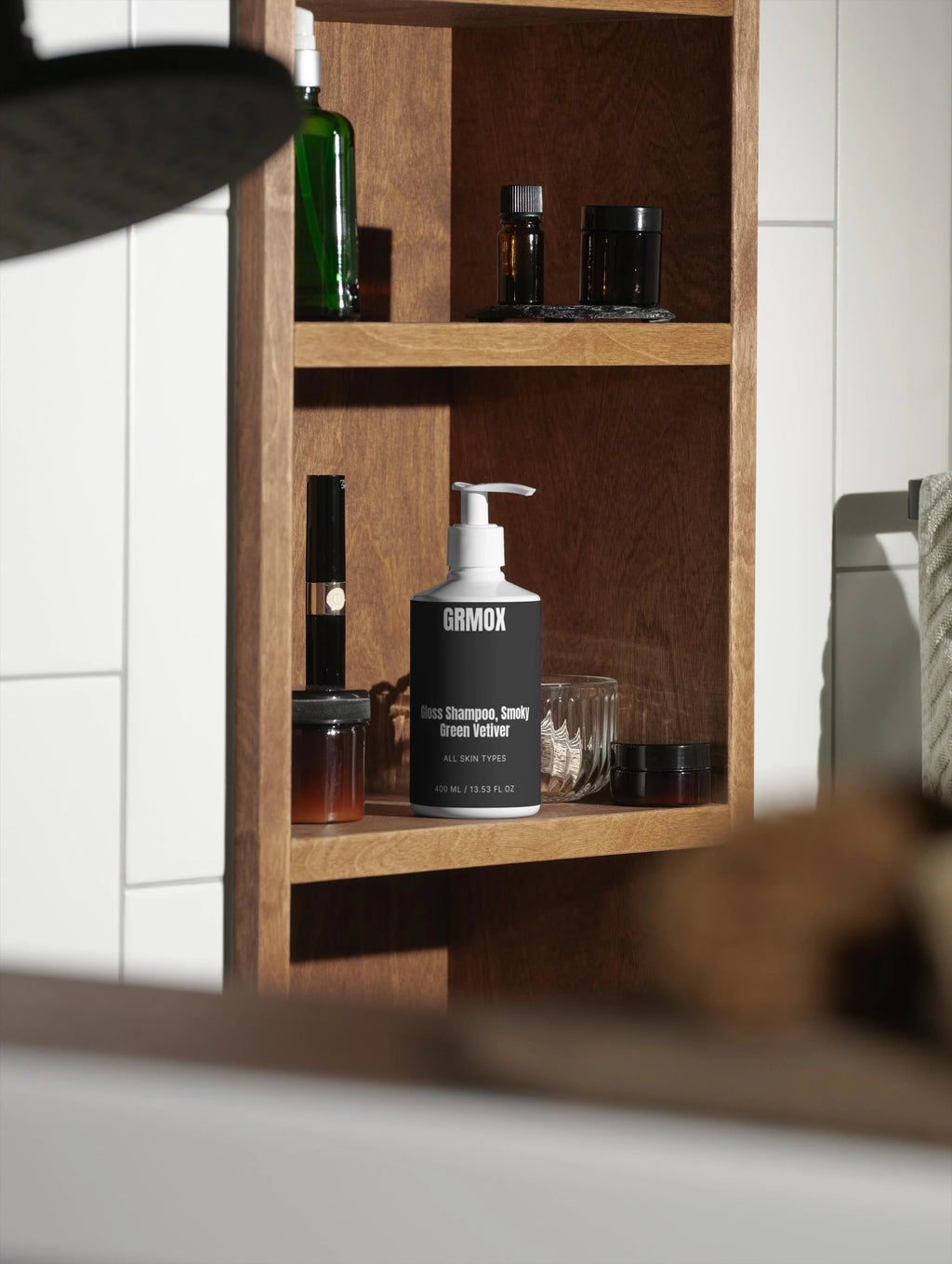 GRMOX Gloss Shampoo Smoky Green Vetiver on wooden bathroom shelf with skincare products
