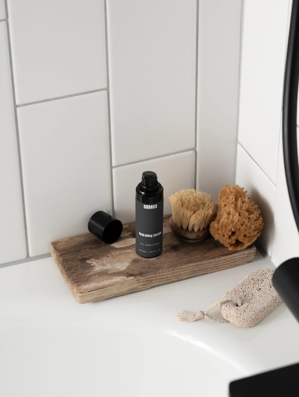 GRMOX Hydrating Serum for all skin types on rustic wood tray with bath brush and sponge in bathroom