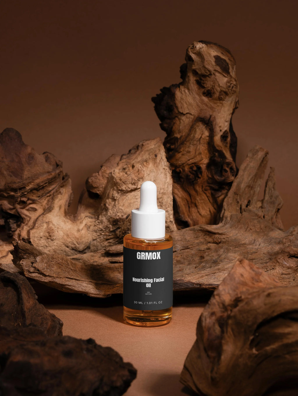 GRMOX Nourishing Facial Oil for dry mature skin, 30ml bottle with dropper, displayed on rustic wood background