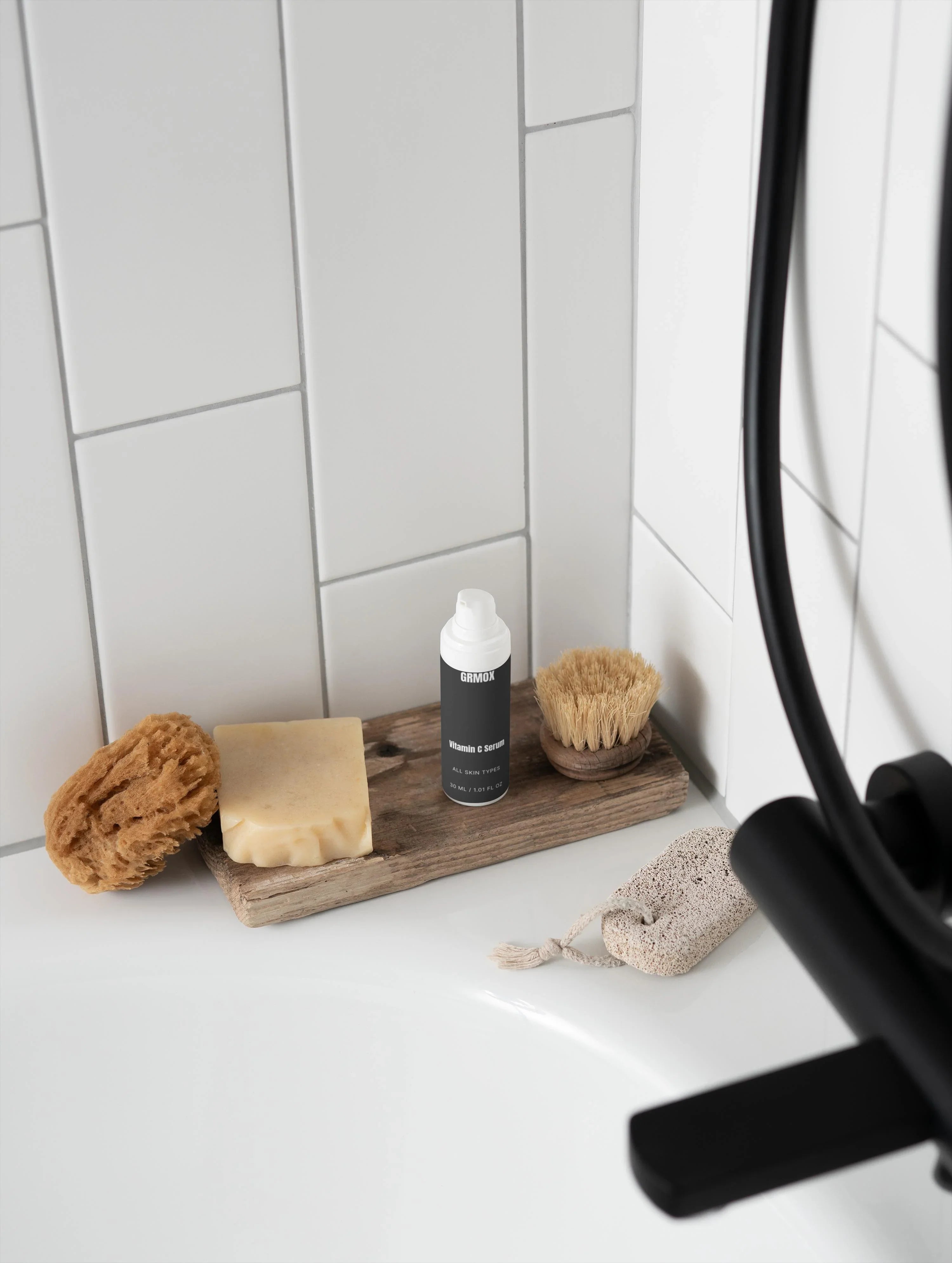 Vitamin C serum for all skin types on bathroom shelf with soap, sponge, and brush
