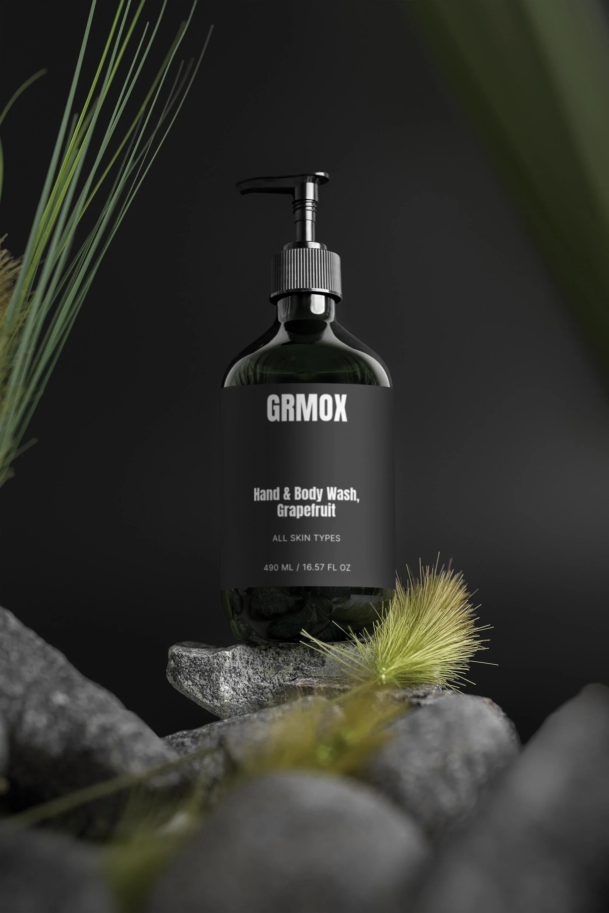 GRMOX Hand & Body Wash, Grapefruit scent for all skin types, 490ml bottle on rocks with greenery