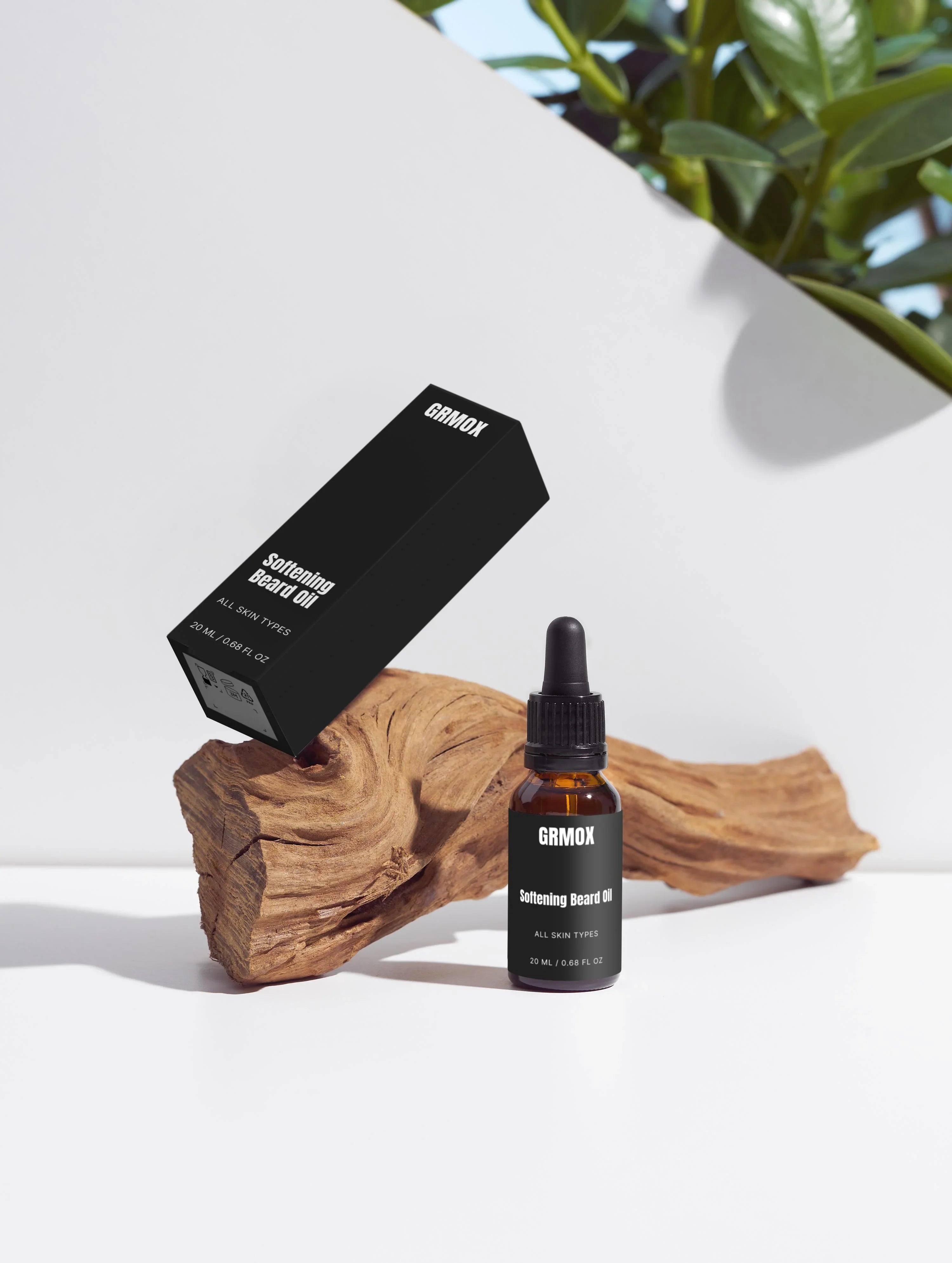 Softening Beard Oil for all skin types, 20ml bottle with dropper and packaging on wood, green plant background