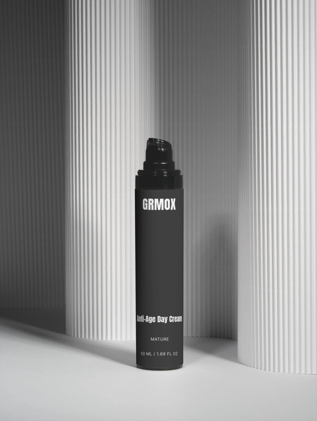 GRMOX Anti-Age Day Cream for mature skin, 50ml, sleek black bottle against modern striped backdrop