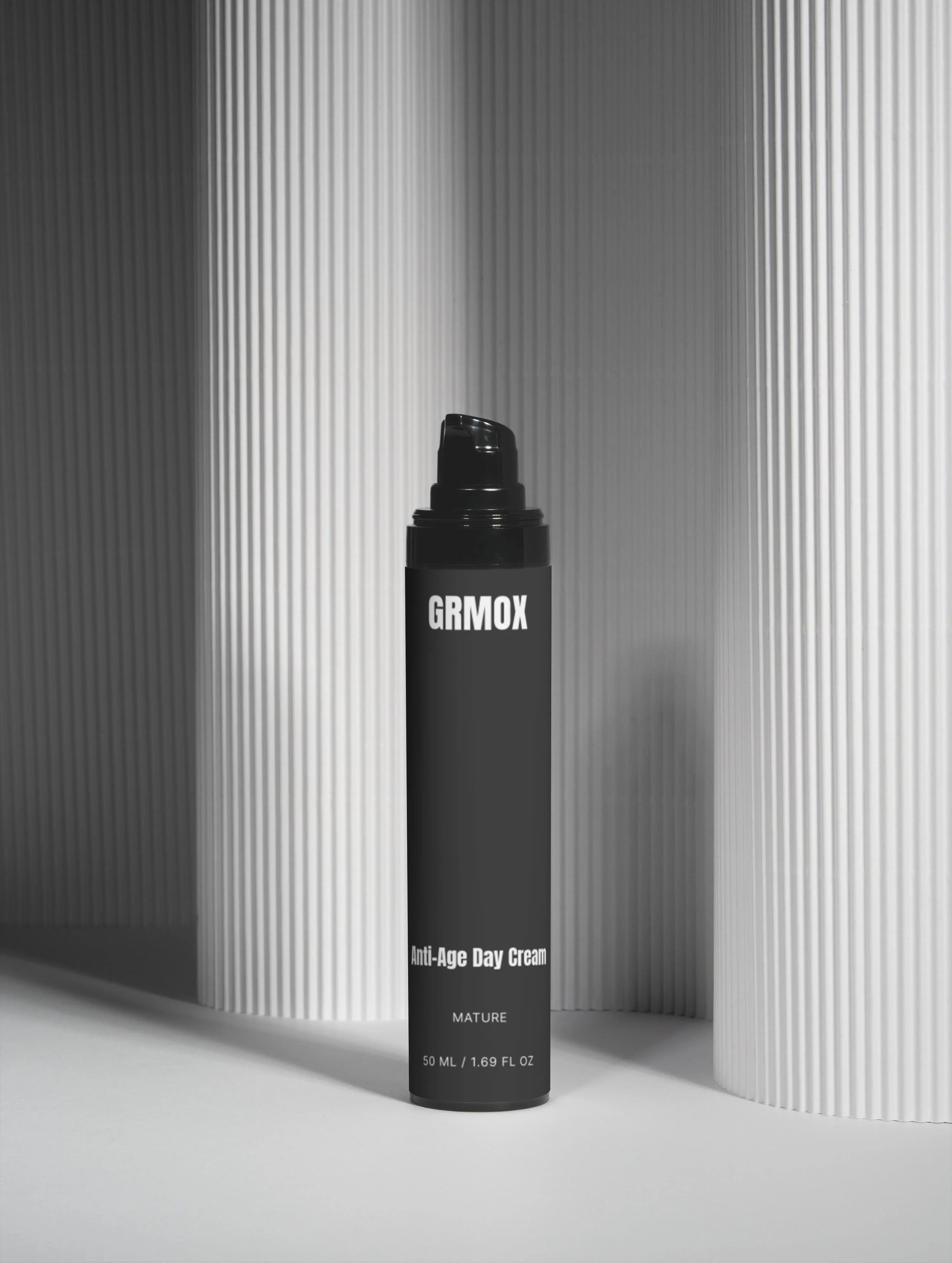 GRMOX Anti-Age Day Cream for mature skin, 50ml, sleek black bottle against modern striped backdrop