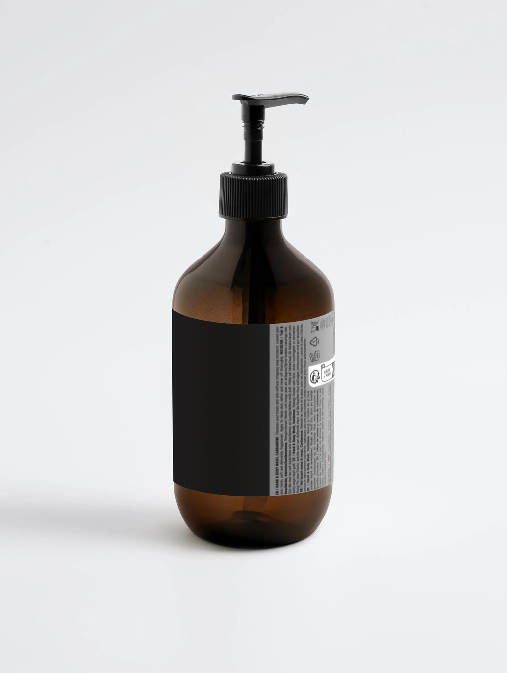 Amber glass bottle with black pump dispenser, minimalist label design for hand and body wash