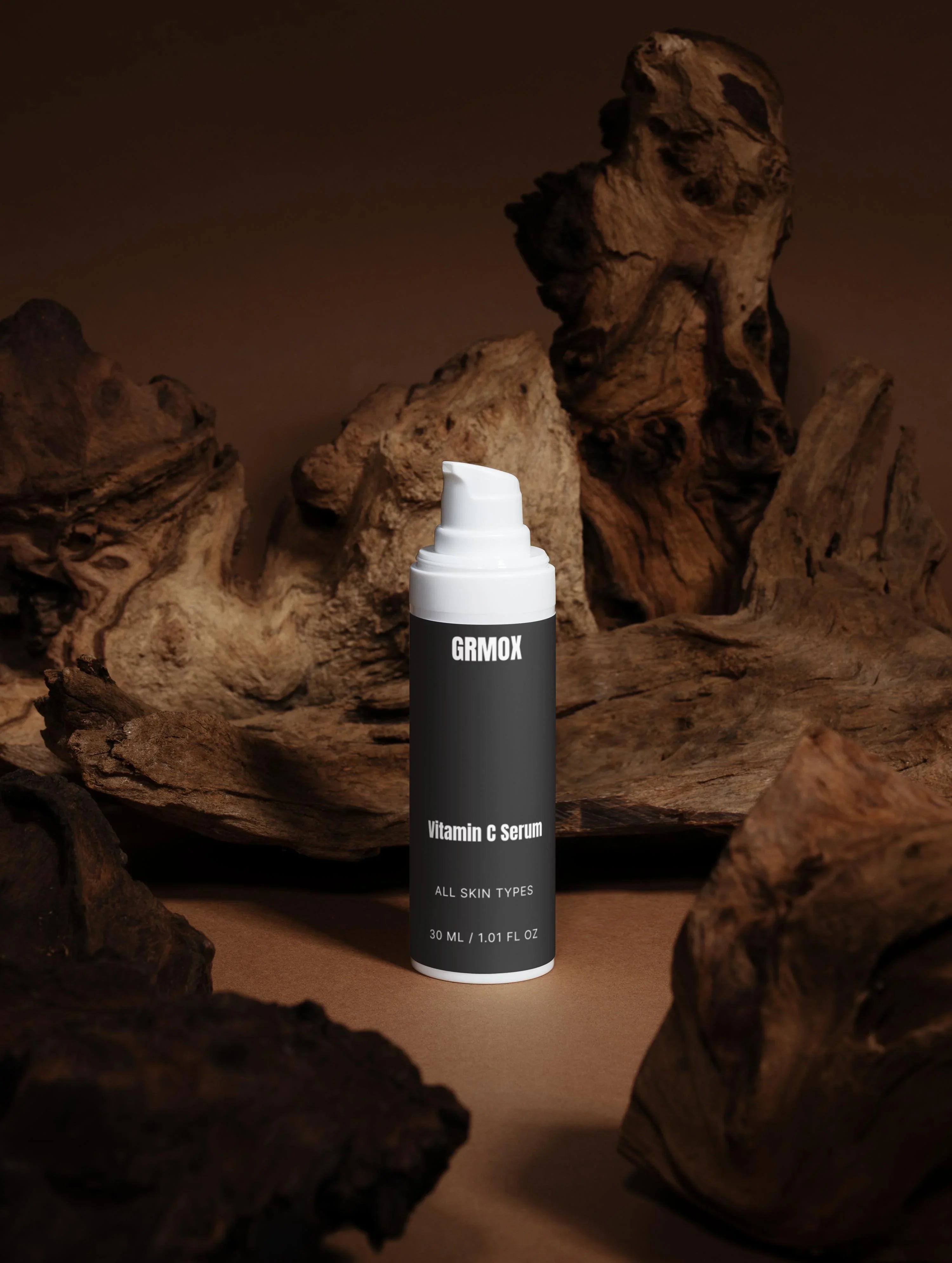 GRMOX Vitamin C Serum for all skin types, 30ml bottle with pump, displayed on rustic wood background