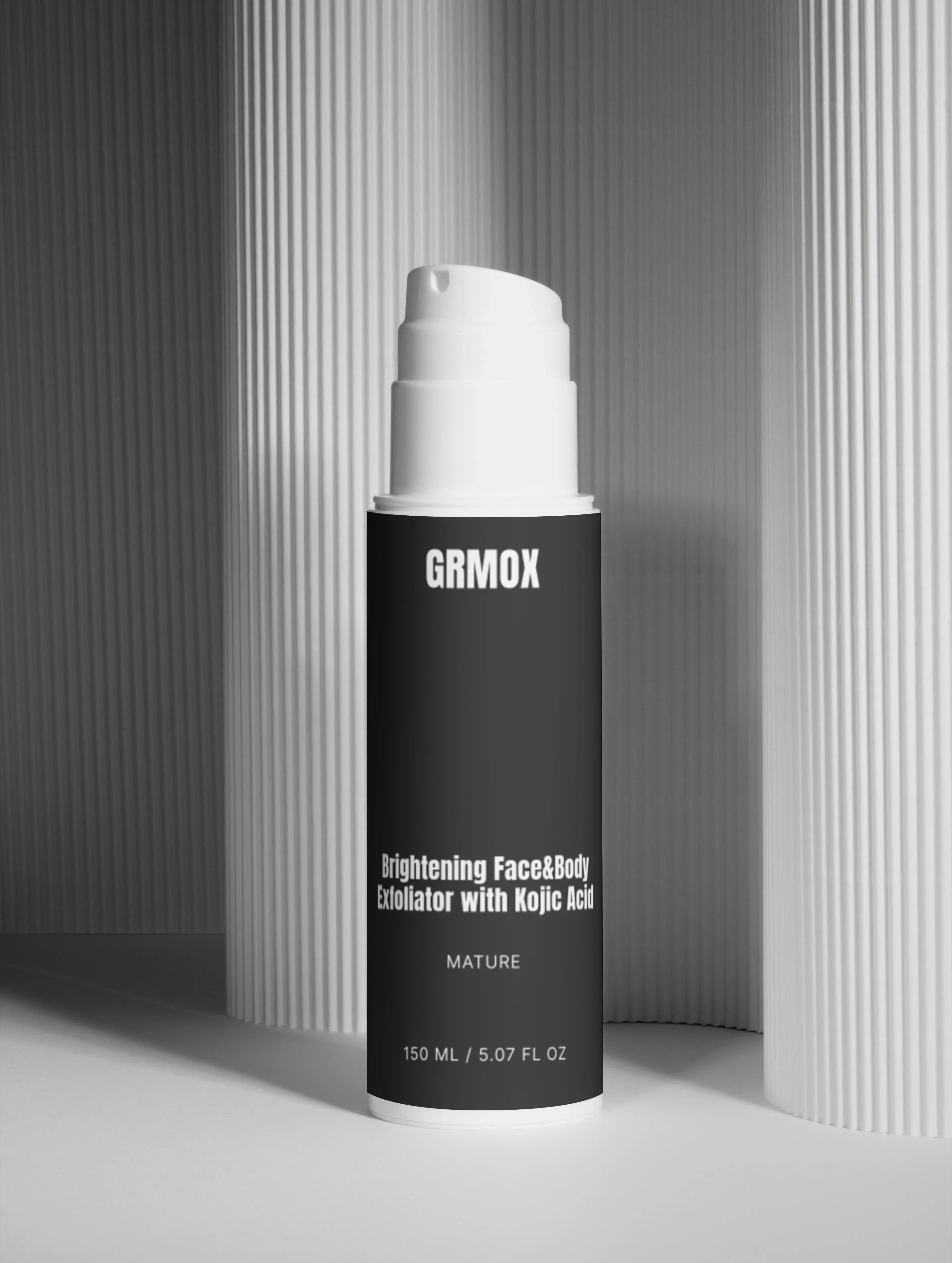 Brightening face and body exfoliator with kojic acid in sleek black bottle, 150ml