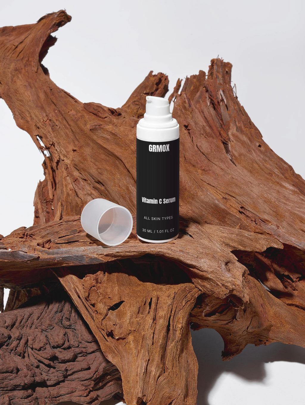 GRMOX Vitamin C Serum for all skin types, 30ml bottle on rustic wood, antioxidant skincare