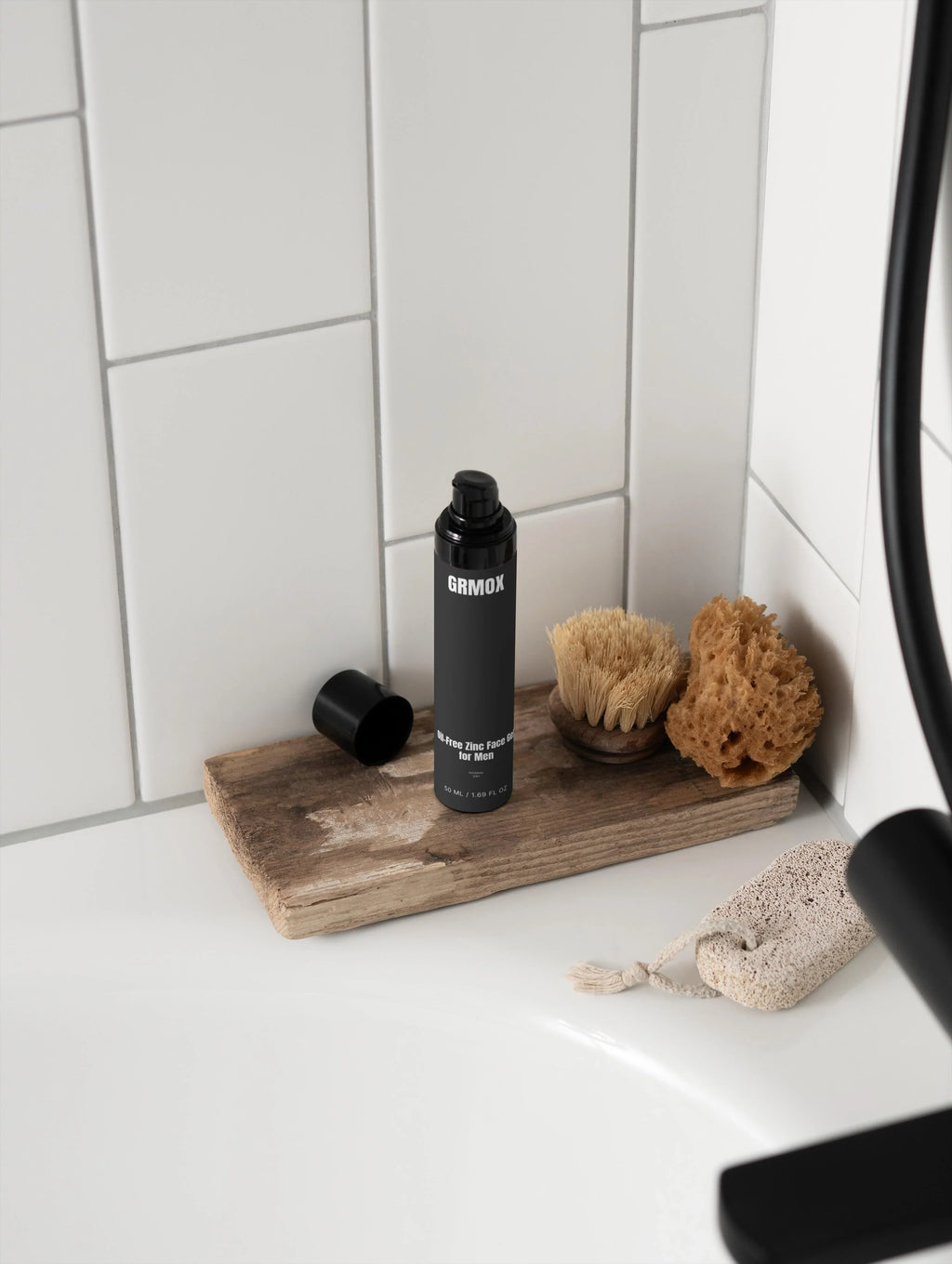 Oil-Free Zinc Face Gel for Men on rustic wood tray with bath brush and sponge in white tiled bathroom
