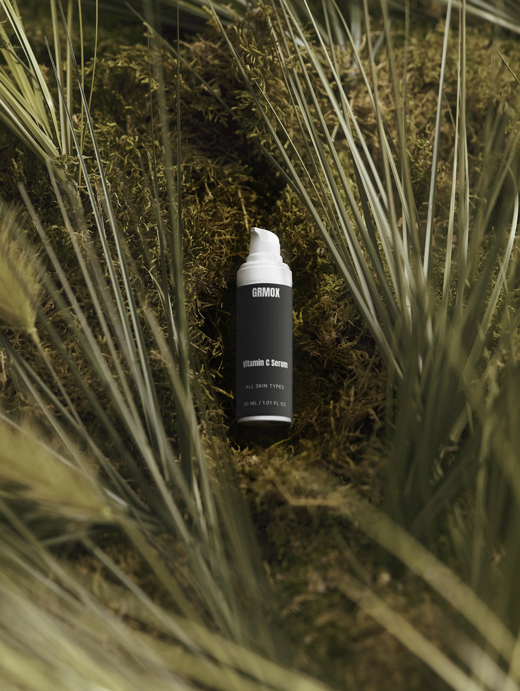 GRMOX Vitamin C Serum for all skin types, nestled in moss with grass, 30ml bottle