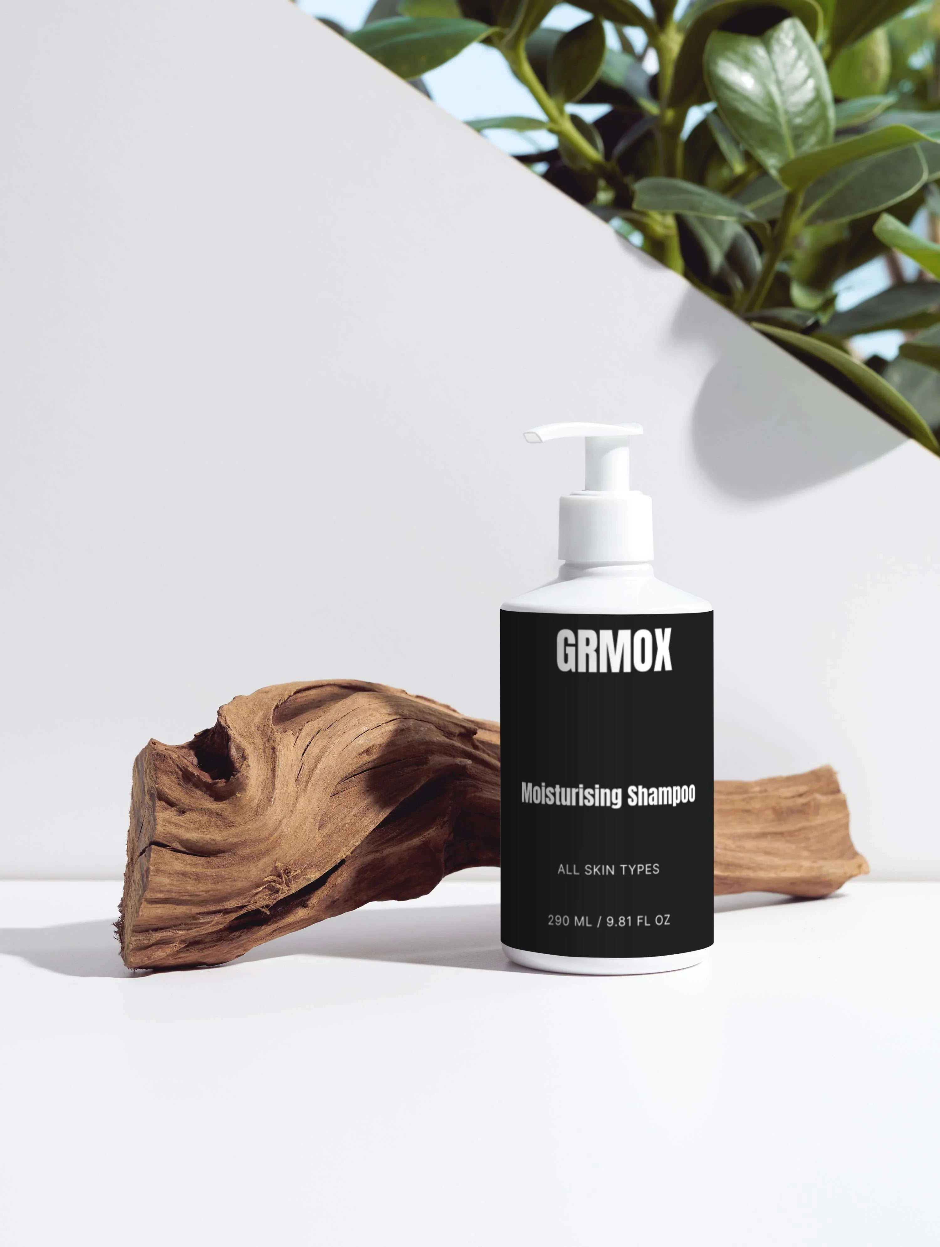 GRMOX Moisturising Shampoo for all skin types, 290ml bottle with pump, styled with driftwood and green plant on white background