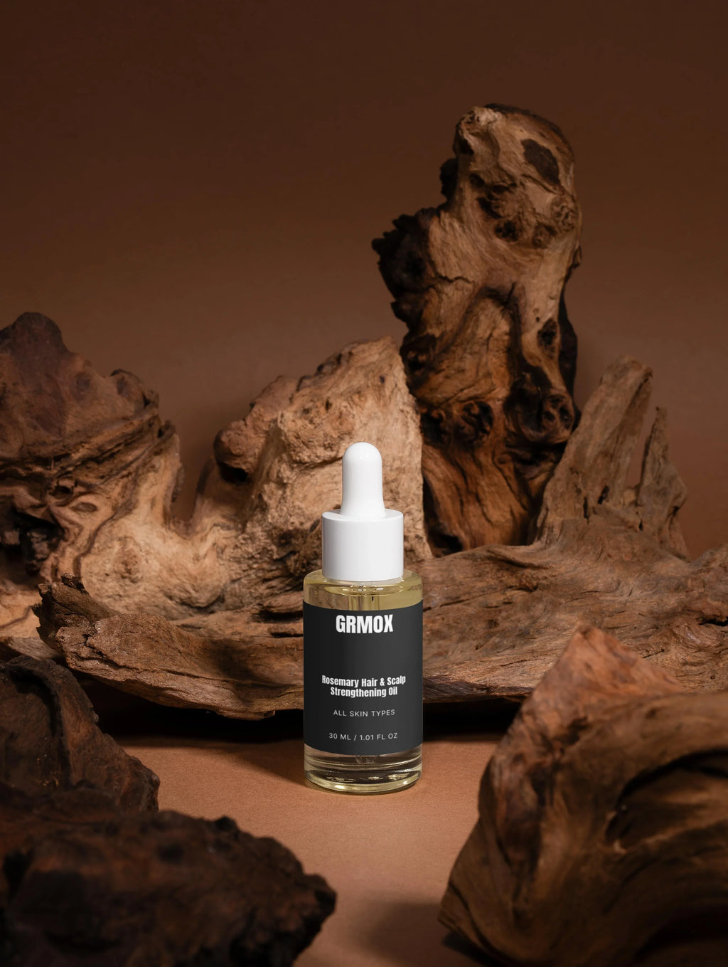 GRMOX Rosemary Hair & Scalp Strengthening Oil for all skin types, 30ml bottle with dropper on rustic wood background