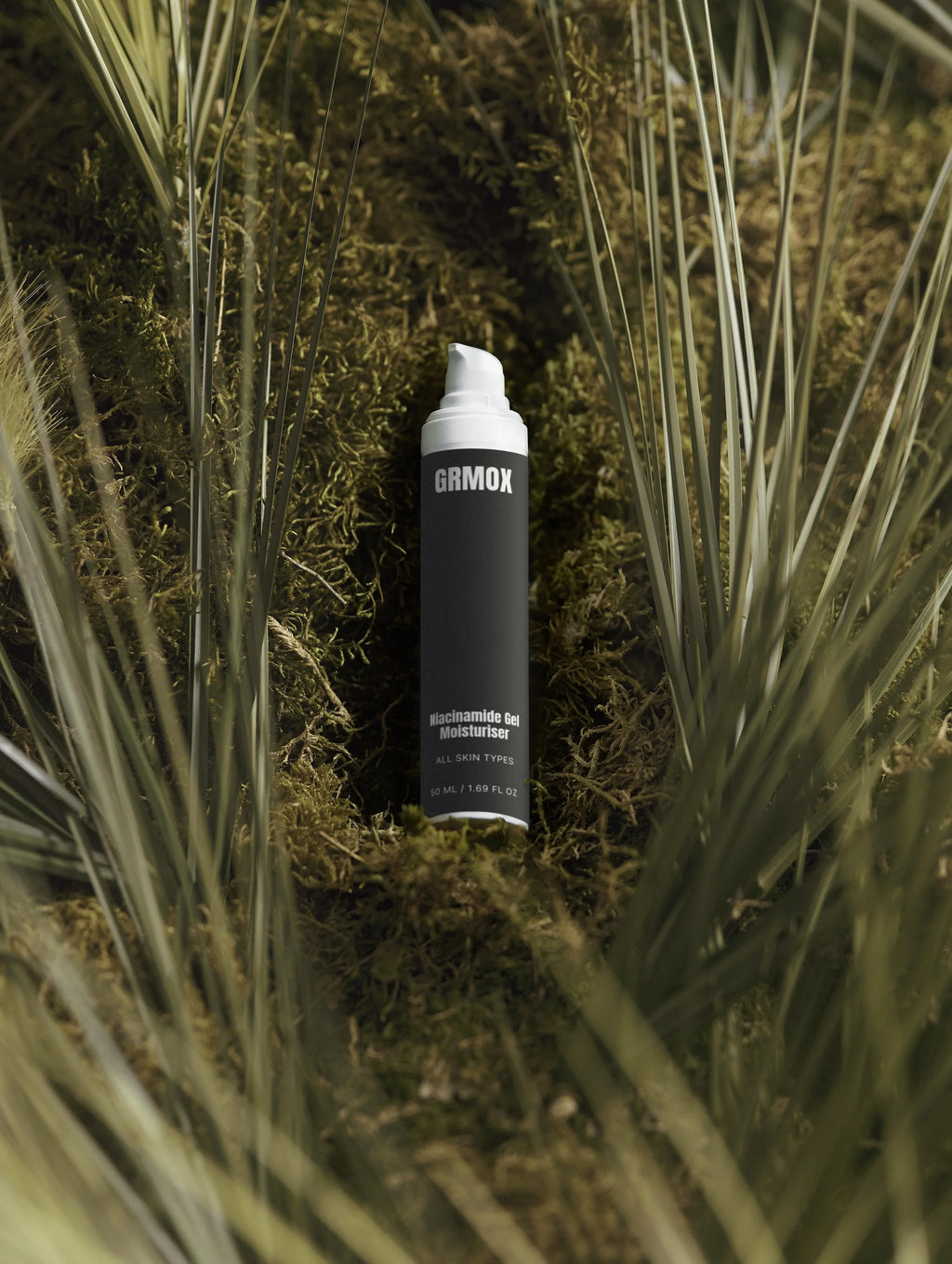 GRMOX Niacinamide Gel Moisturiser for all skin types, nestled in mossy greenery