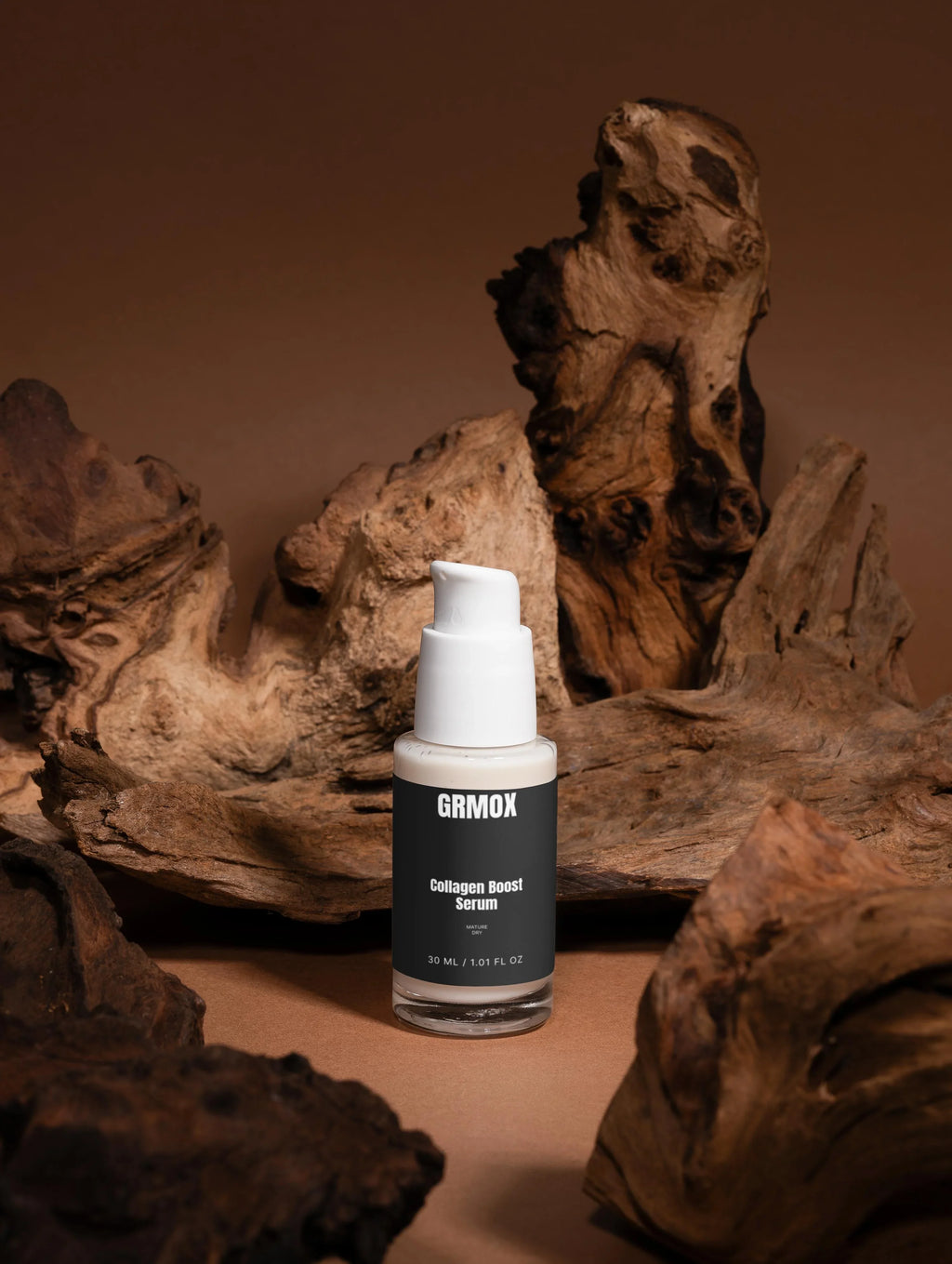 GRMOX Collagen Boost Serum for mature dry skin, 30ml bottle with pump, displayed on rustic driftwood