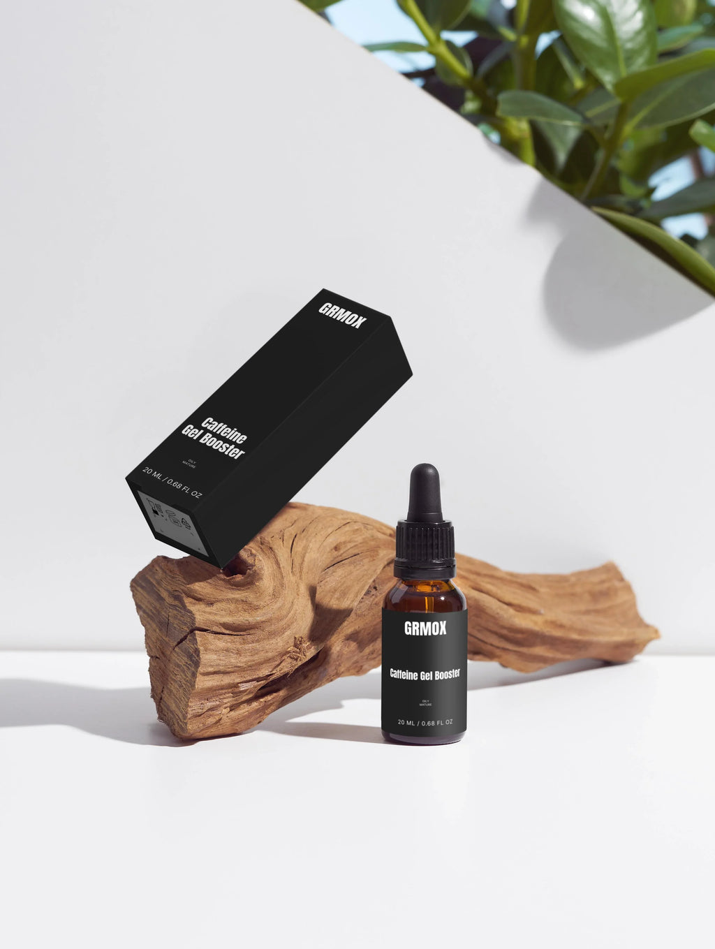 Caffeine Gel Booster in dropper bottle and box, 20ml, for oily mature skin, displayed on wood with green plant.