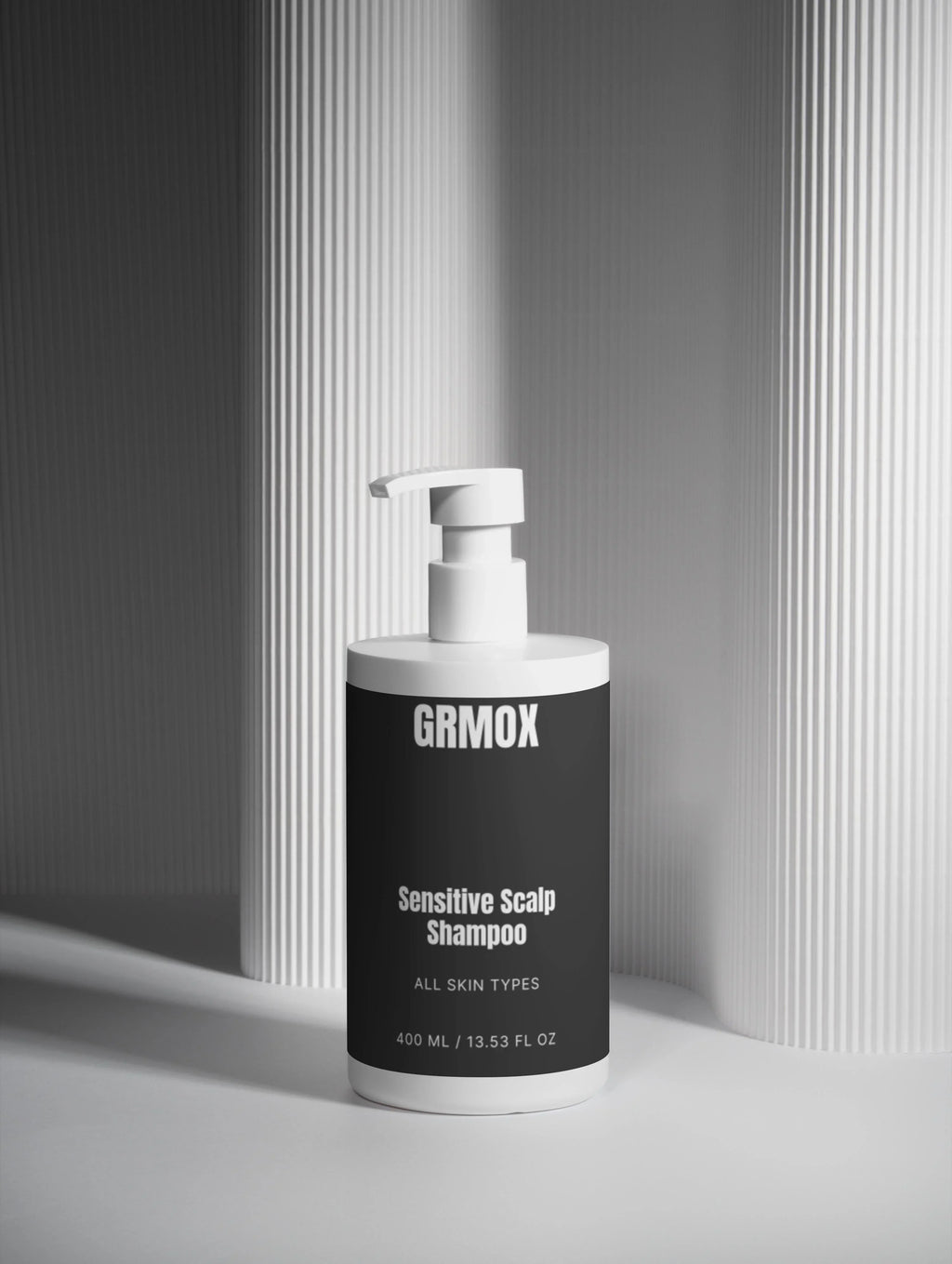GRMOX Sensitive Scalp Shampoo for all skin types, 400ml bottle with pump dispenser on striped background