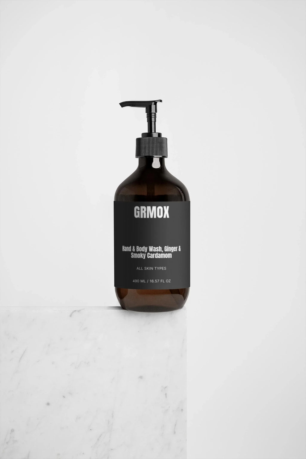 GRMOX Hand & Body Wash with Ginger & Smoky Cardamom scent, 490ml bottle on marble surface