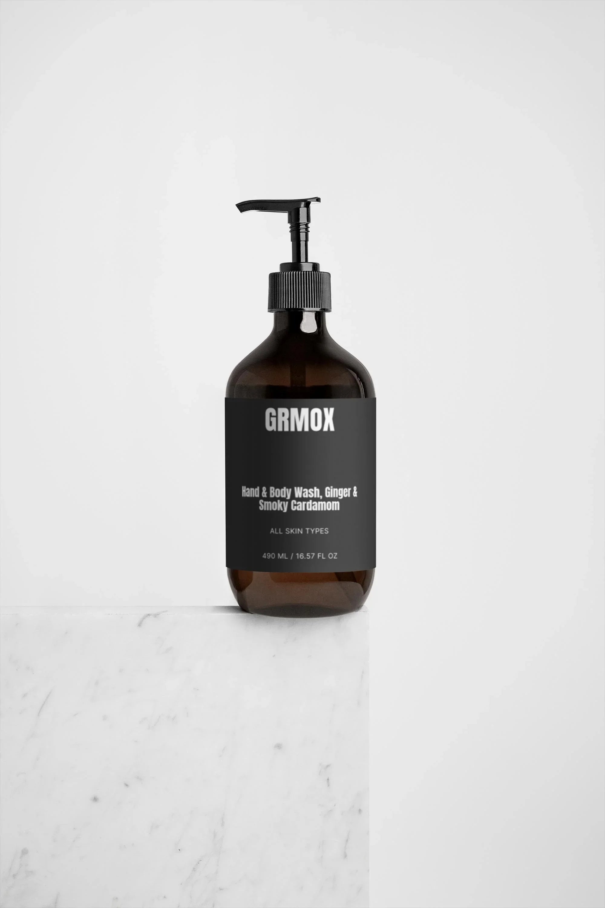 GRMOX Hand & Body Wash with Ginger & Smoky Cardamom scent, 490ml bottle on marble surface