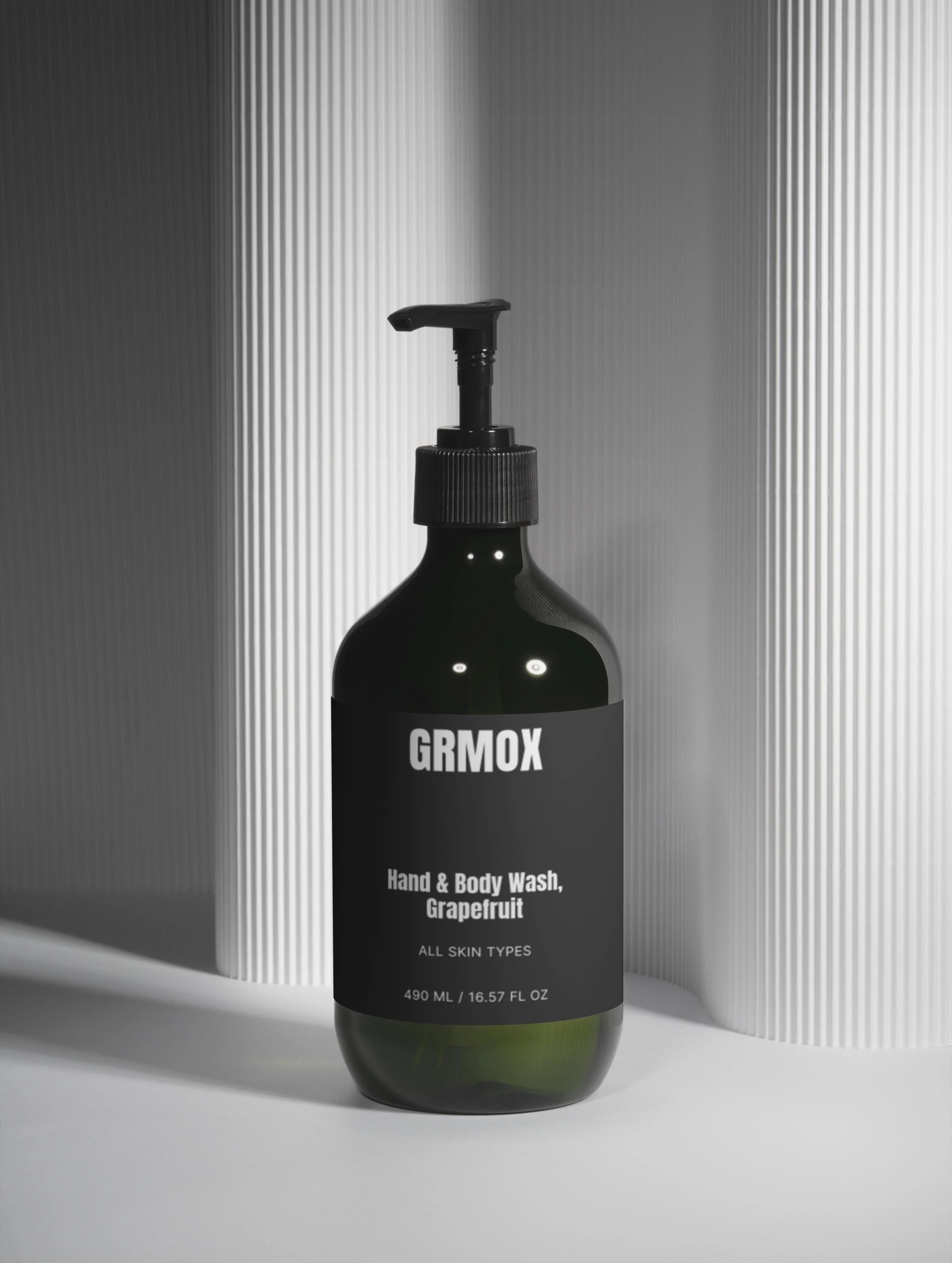 GRMOX Hand & Body Wash Grapefruit for all skin types, 490ml pump bottle on modern striped background