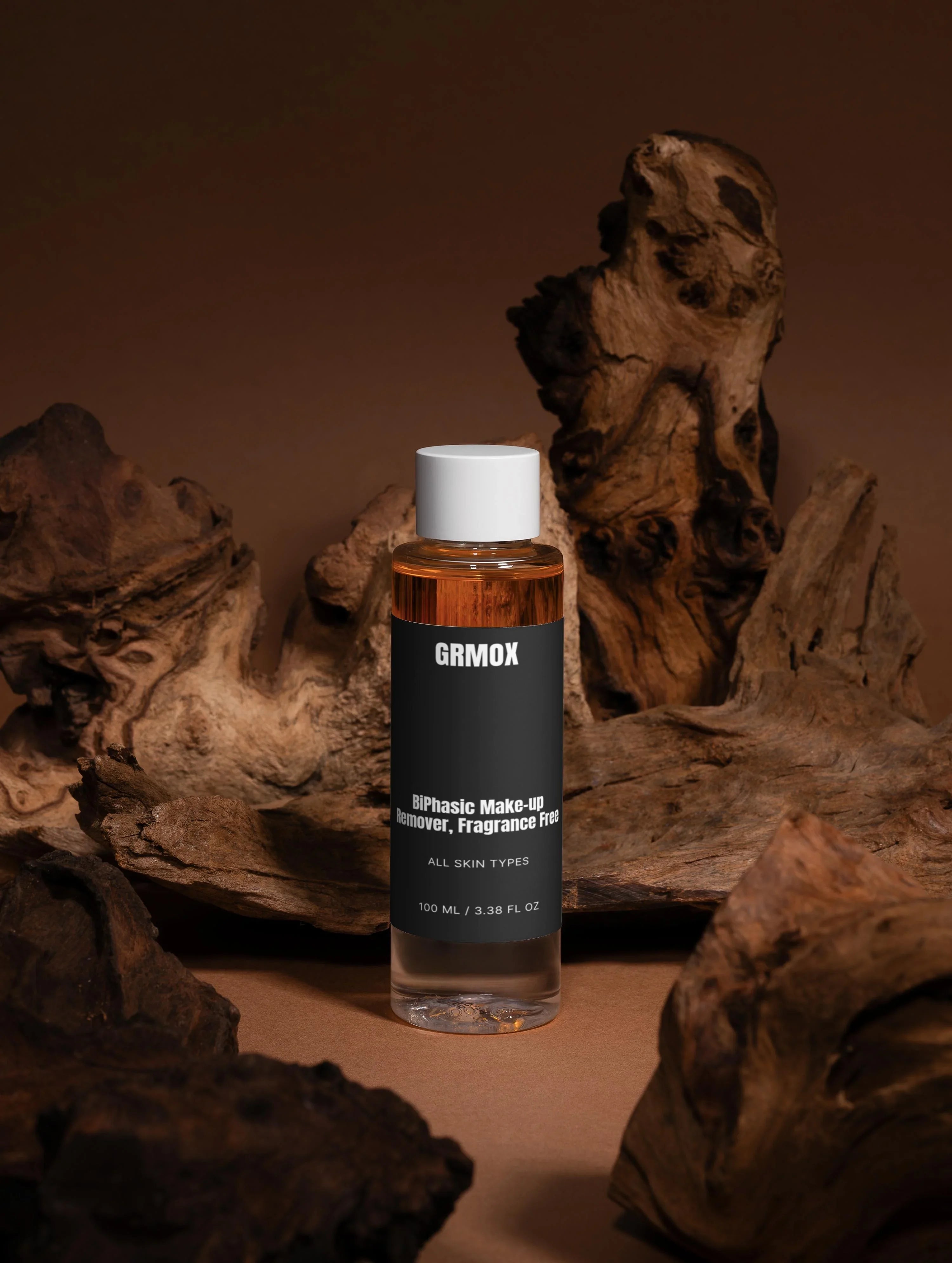 GRMOX BiPhasic Makeup Remover, fragrance-free, for all skin types, 100ml bottle with driftwood background