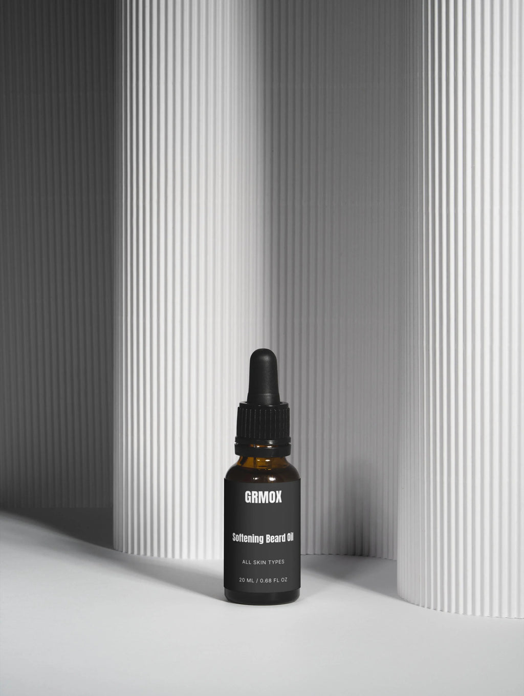 GRMOX Softening Beard Oil for all skin types, 20ml bottle with dropper on minimalist striped background