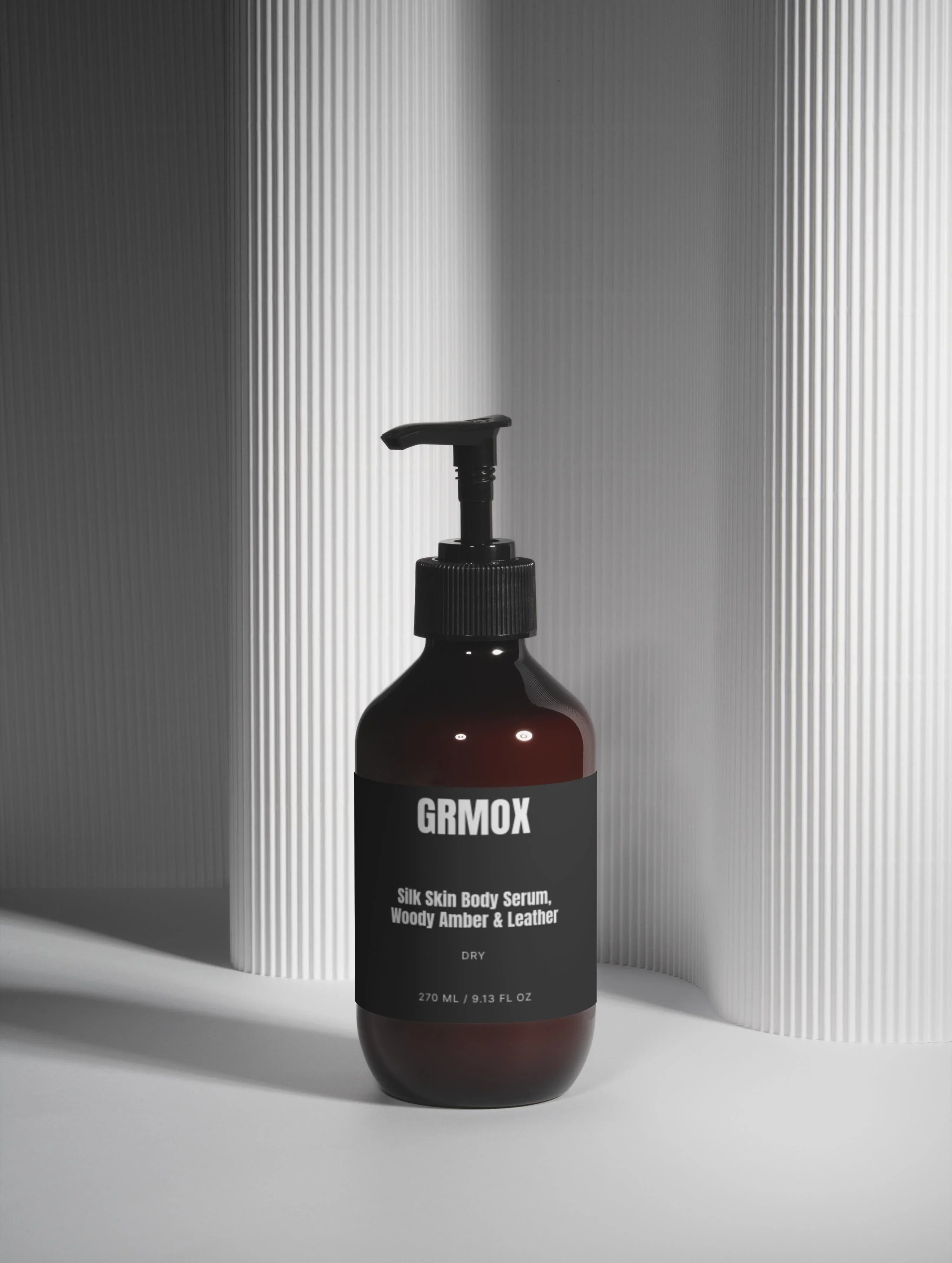 Silk Skin Body Serum with Woody Amber & Leather scent in amber glass bottle, 270ml