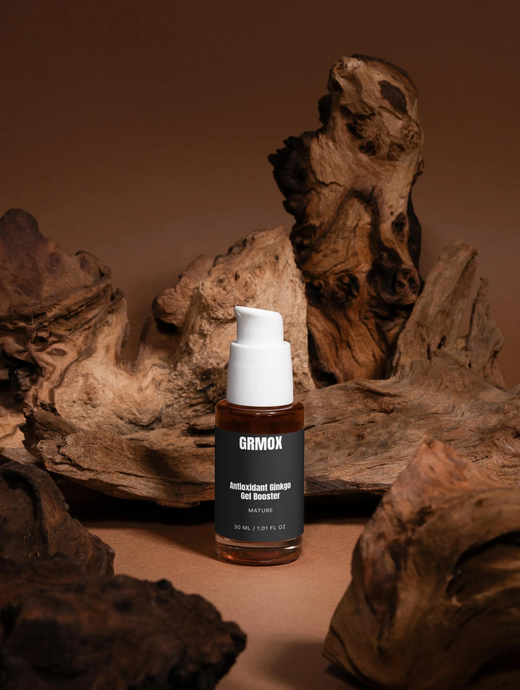 GRMOX Antioxidant Ginkgo Gel Booster in amber bottle with white pump, displayed on rustic driftwood background