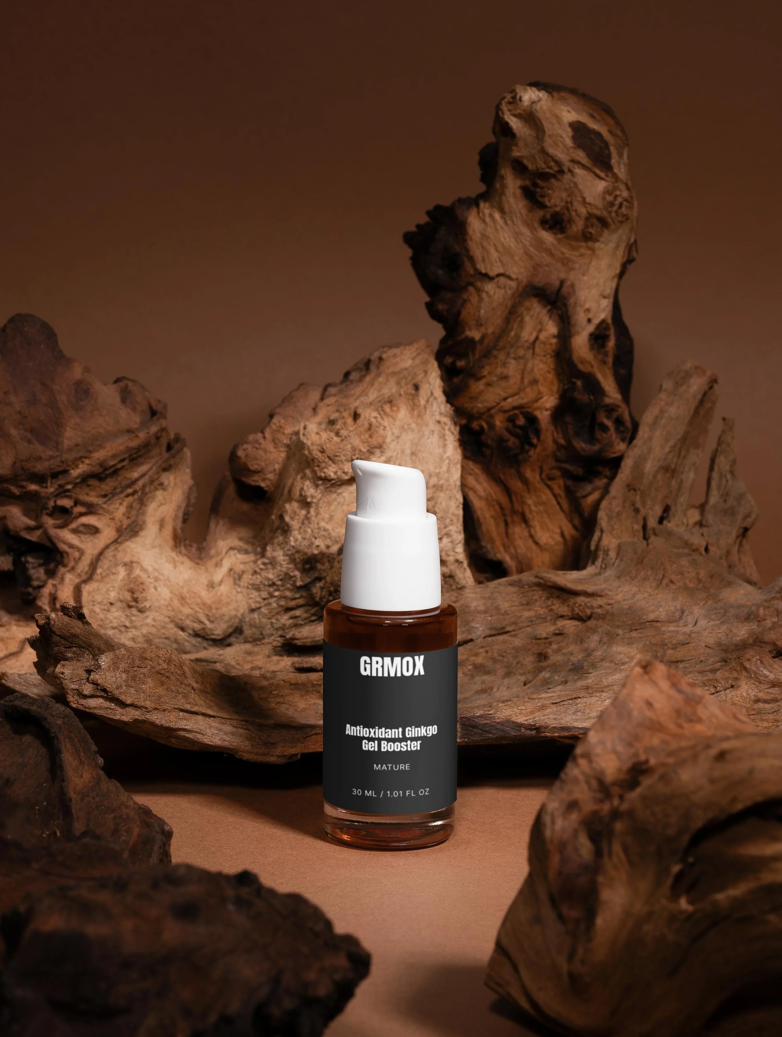GRMOX Antioxidant Ginkgo Gel Booster in amber bottle with white pump, displayed on rustic driftwood background